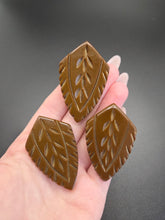 Load image into Gallery viewer, 1940s Chocolate Brown Carved Bakelite Triple Dress Clip Set

