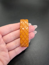 Load image into Gallery viewer, 1940s Butterscotch Carved Bakelite Curved Dress Clip
