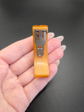 Load image into Gallery viewer, 1940s Butterscotch Carved Bakelite Curved Dress Clip
