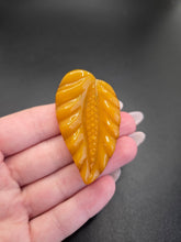 Load image into Gallery viewer, 1940s Carved Egg Yolk Bakelite Dress Clip
