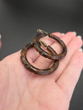 Load image into Gallery viewer, 1940s Marbled Brown Carved Bakelite Hoop Earrings
