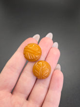 Load image into Gallery viewer, 1940s Carved Orange Bakelite Earrings
