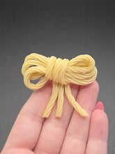 Load image into Gallery viewer, 1940s Spaghetti Celluloid Bow Brooch
