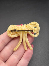 Load image into Gallery viewer, 1940s Spaghetti Celluloid Bow Brooch

