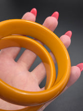 Load image into Gallery viewer, 1940s Egg Yolk Bakelite Bangle Set
