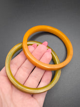 Load image into Gallery viewer, 1940s Curved Marbled Green and Orange Bakelite Bangle Set
