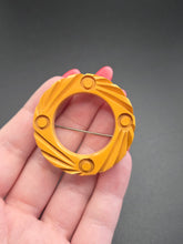 Load image into Gallery viewer, 1940s Carved Bakelite Dark Yellow Circle Brooch
