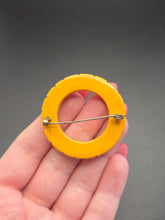 Load image into Gallery viewer, 1940s Carved Bakelite Dark Yellow Circle Brooch
