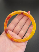 Load image into Gallery viewer, 1930s Bright Marbled Orange and Yellow Galalith Bangle
