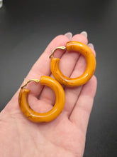 Load image into Gallery viewer, 1940s Chunky Yellow Orange Marbled Bakelite Hoop Earrings

