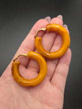 Load image into Gallery viewer, 1940s Chunky Yellow Orange Marbled Bakelite Hoop Earrings
