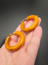 Load image into Gallery viewer, 1940s Chunky Yellow Orange Marbled Bakelite Hoop Earrings
