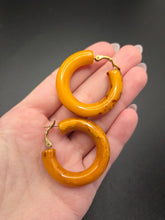 Load image into Gallery viewer, 1940s Chunky Yellow Orange Marbled Bakelite Hoop Earrings
