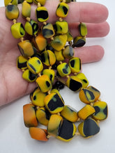 Load image into Gallery viewer, 1950s Black, Yellow and Orange Marbled Knotted Glass Necklace
