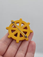Load image into Gallery viewer, 1940s Butterscotch Bakelite Ships Wheel Brooch
