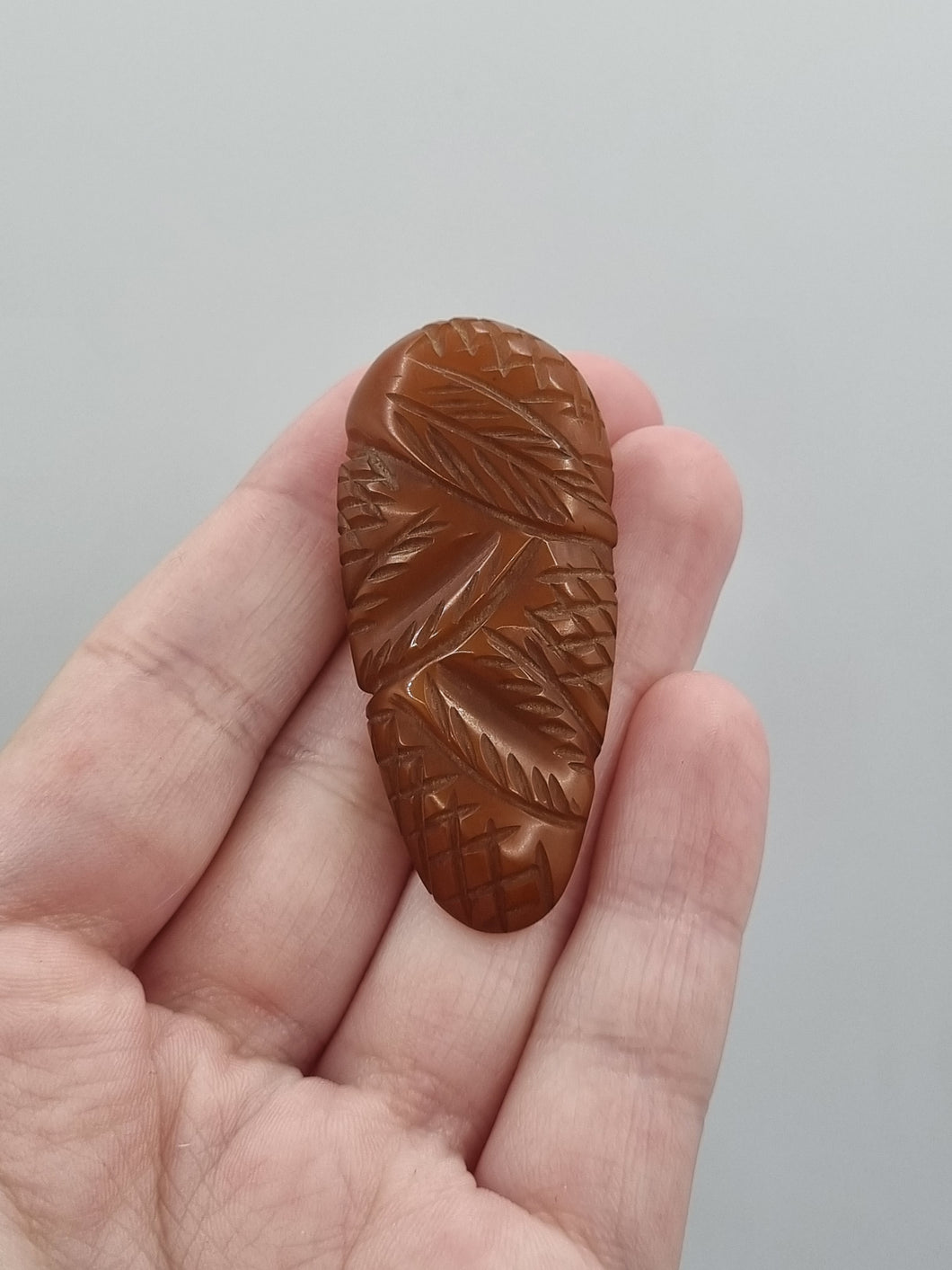 1940s Dark Marmalade Carved Bakelite Dress Clip