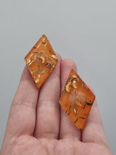 Load image into Gallery viewer, 1950s Orange Moon Confetti Lucite Clip Earrings
